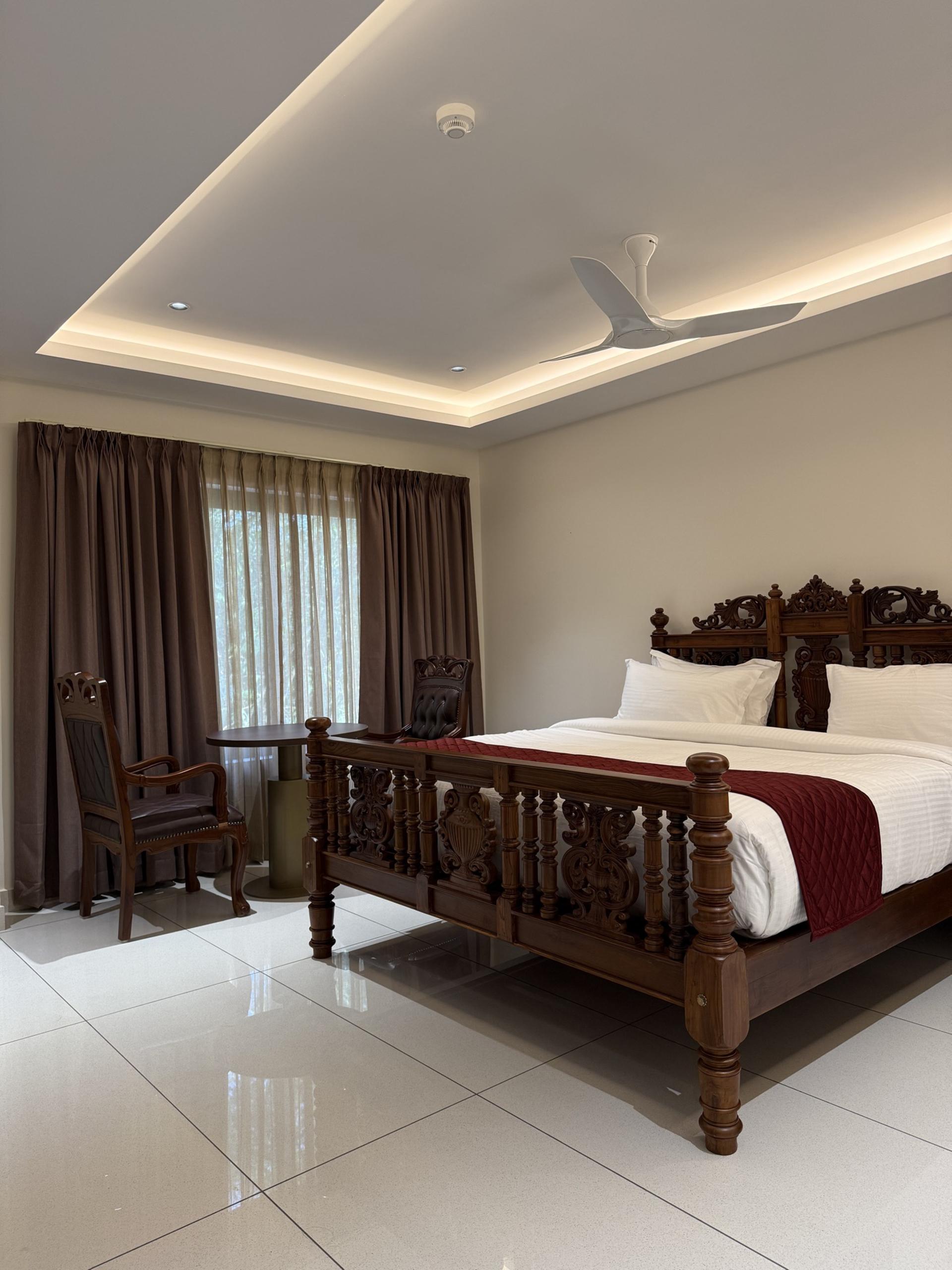 Deluxe Room with carved wooden bed